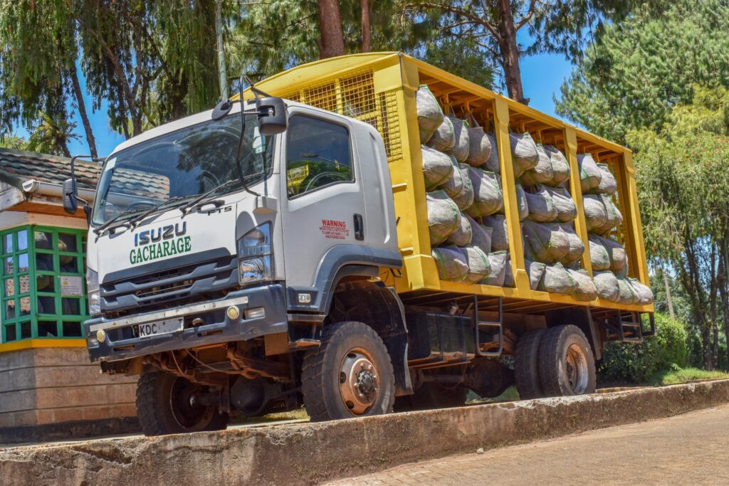 A Gacharage collection truck loaded with sacks of green leaf at the factory